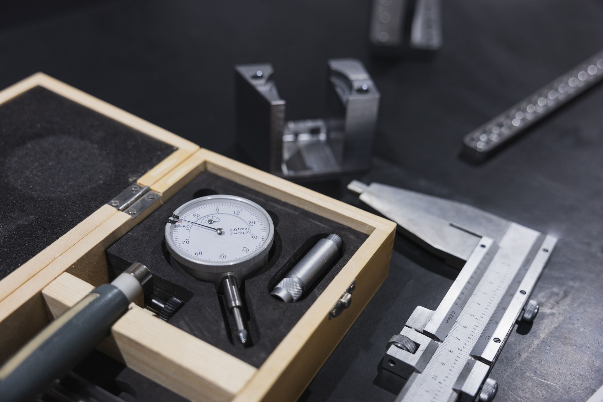 Precision at Work. Dial indicator and caliper for precision measuring.