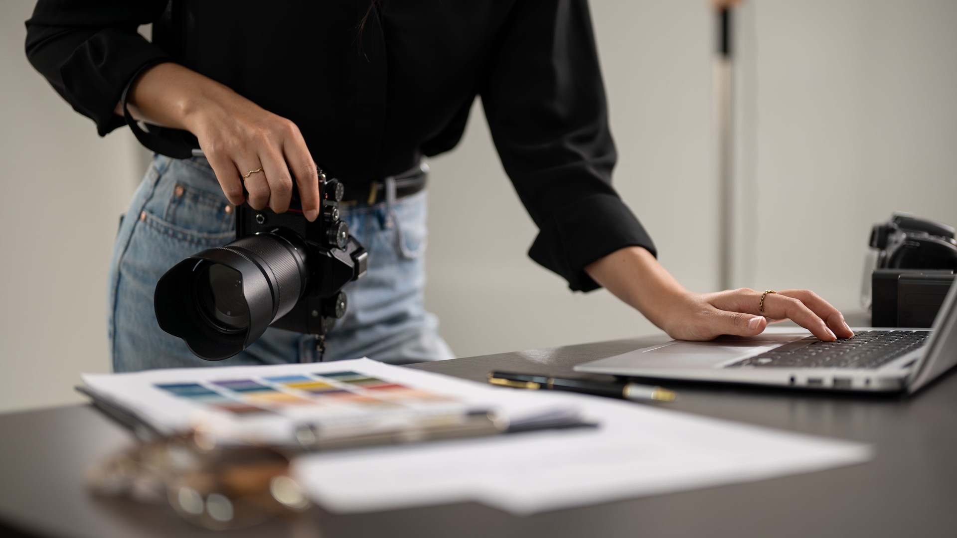 A cropped shot of a female photographer checking images on a laptop computer in a studio.